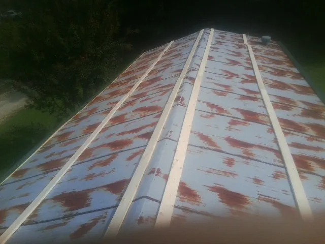 Rusted metal roof panels with new wood purlins before replacement — Storm Damage Roof Repair in Steen by Roofing Brothers