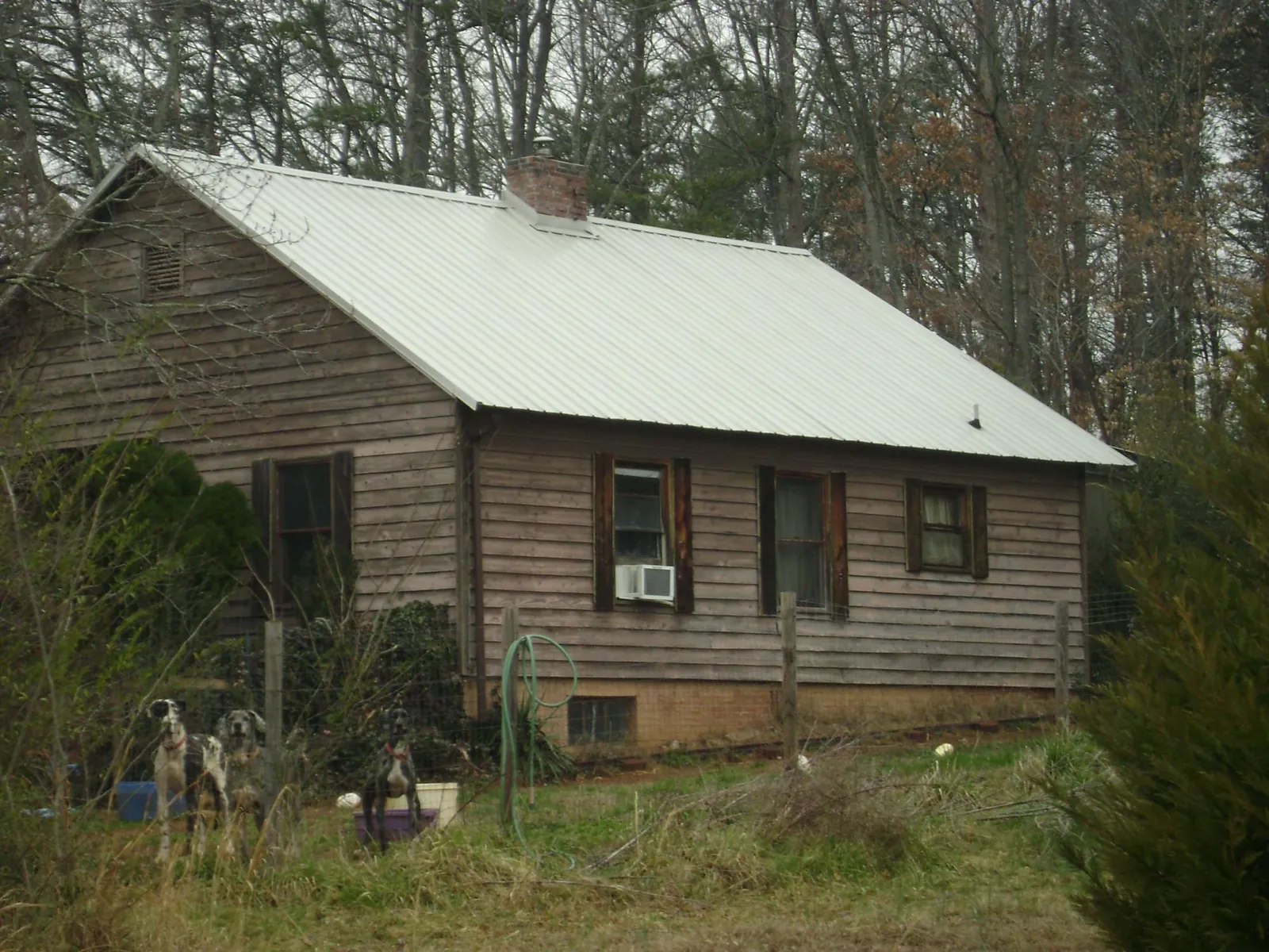 White metal roof on an old wood sided farmhouse, from a Metal Roof Installation job in Steen